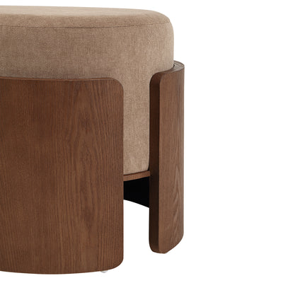 Close-up of a modern upholstered stool or ottoman with a beige fabric seat and curved medium-brown wooden side panels, shown on a white background.